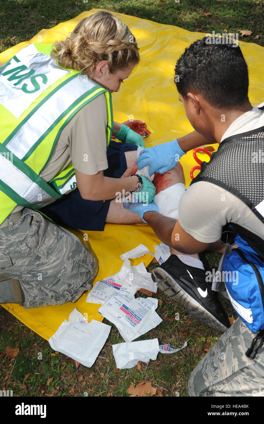 Senior Airman Tanya Schroeder, 81st Medical Operations Squadron, and Airman 1st Class James Rodriguez, 81st Aerospace Medicine Squadron, wrap the wound of a 'victim' in the triage area before transporting him to the Keesler Hospital during a hazardous material exercise, Sept. 27, 2012, at Keesler Air Force Base, Miss. In the scenario a routine delivery flatbed trailer transporting hazardous material is struck by a van transporting airmen causing one of the containers to fall from the vehicle and rupture. The exercise helped prepare first responders in the event of a real-world incident.   Kemb Stock Photo