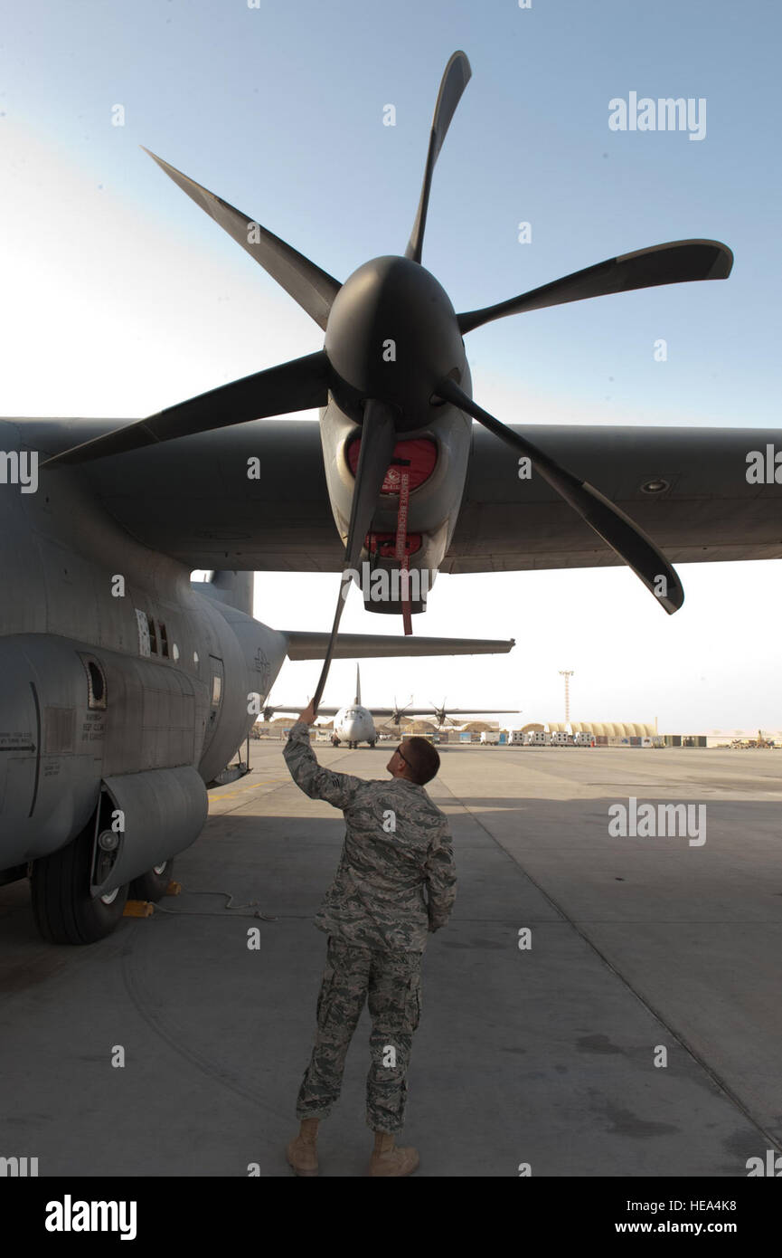 Senior Airman Tyler Racca, 746th Expeditionary Aircraft Maintenance Unit crew chief, inspects a C-130J for damage to ensure serviceability, Sept. 22, in Southwest Asia. The 746 EAMU supports deployed C-130Js which provide intra-theater combat airlift support throughout Southwest Asia. Racca is deployed from Keesler Air Force Base, Miss., in support of Operations Iraqi and Enduring Freedom. Stock Photo