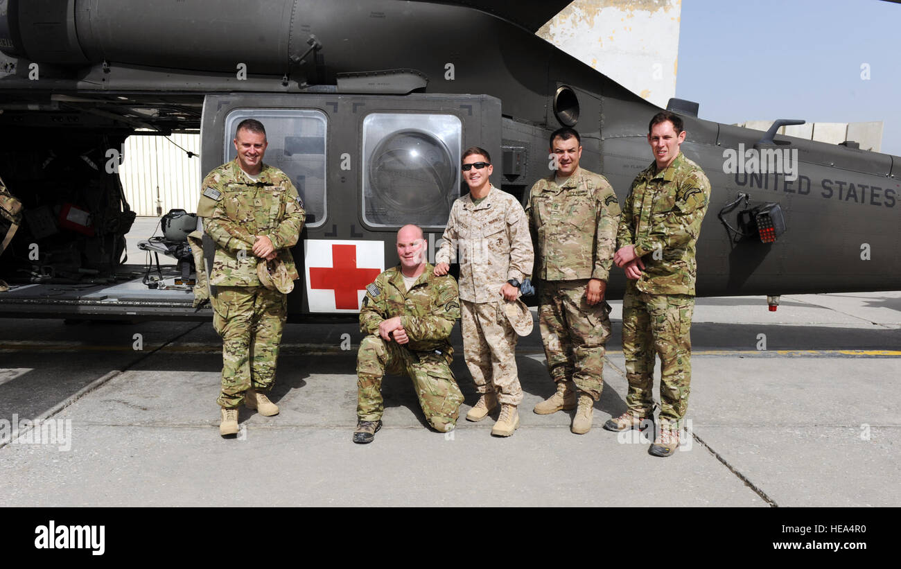 From left, retired Army Cpl. Steve Martin, Army Sgt. Tom Block, Medal of Honor recipient retired Marine Cpl. Kyle Carpenter, Medal of Honor recipient retired Army Master Sgt. Leroy Petry and retired Army Sgt. Ralph Cacciapaglia, pose in front of an HH-60 medical evacuation helicopter during a visit to the Dustoff ramp April 16, 2015 at Bagram Air Field, Afghanistan. The visit was conducted as part of Operation Proper Exit, a program developed to provide closure for service members severely injured in the line of duty.  Staff Sgt. Whitney Amstutz/released) Stock Photo