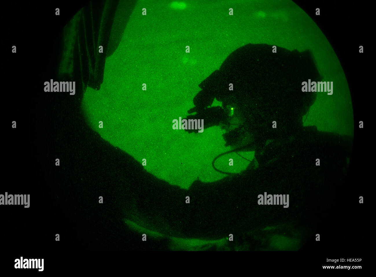 Sgt. Adam Stanley, Marine Heavy Helicopter Squadron 772 crew chief, uses night vision goggles during a night flight on a UH-53 Sea Stallion Mar. 31. HMH 772 is part of Marine Aircraft Group 49 on Joint Base McGuire-Dix-Lakehurst, N.J. Senior Airman Joshua King/released) Stock Photo