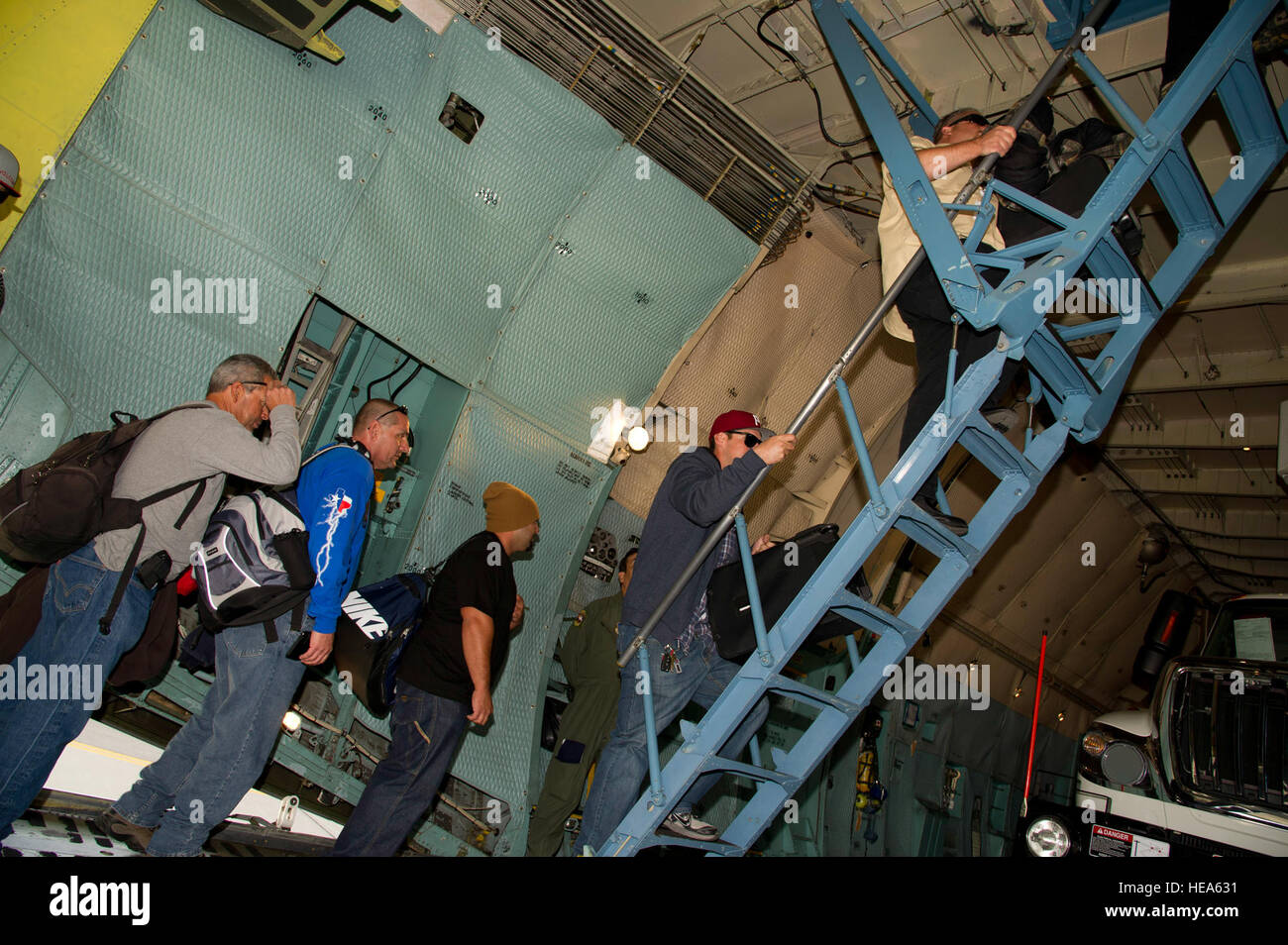 Employees of San Diego Gas and Electric board a U.S. Air Force C5