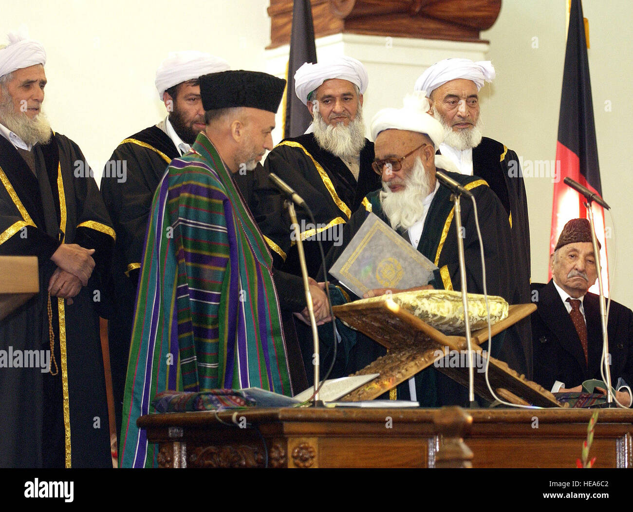 041207-F-5586B-025 Afghanistan President Hamid Karzai (left) is congratulated by Chief Justice of the Supreme Court of Afghanistan Faisal Ahmad Shinwari (right) after he was administered the oath of office during the Presidential Inauguration at Salaam Khana in Kabul, Afghanistan, on Dec. 7, 2004.  Vice President Richard Cheney and Secretary of Defense Donald H. Rumsfeld led the U.S delegation to the inauguration.   Master Sgt. James M. Bowman, U.S. Air Force.  (Released) Stock Photo
