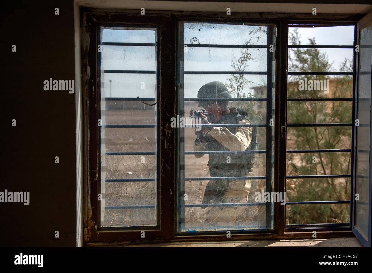 An Iraqi army soldier scans through a window during a close-quarters ...