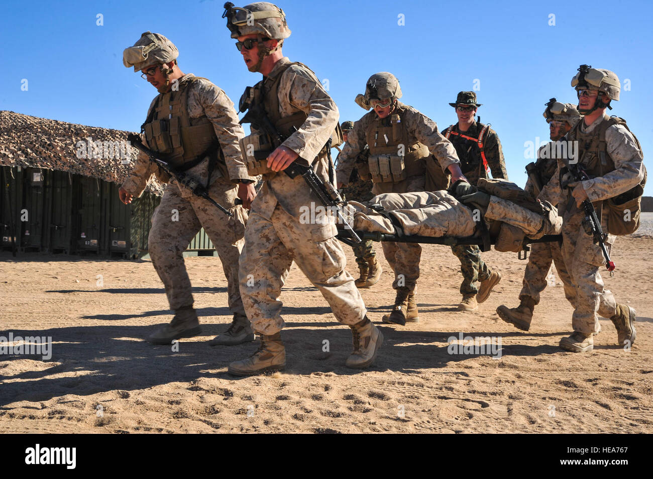 U.S. Marines transport a patient on a liter during Integrated Training Exercise 2-15 at Marine Corps Air Ground Combat Center Twentynine Palms (MCAGCC), Calif., Feb. 11, 2015. MCAGCC conducts relevant live-fire combined arms training, urban operations, and joint/coalition level integration training that promotes operational forces' readiness.  Tech. Sgt. Joselito Aribuabo Stock Photo