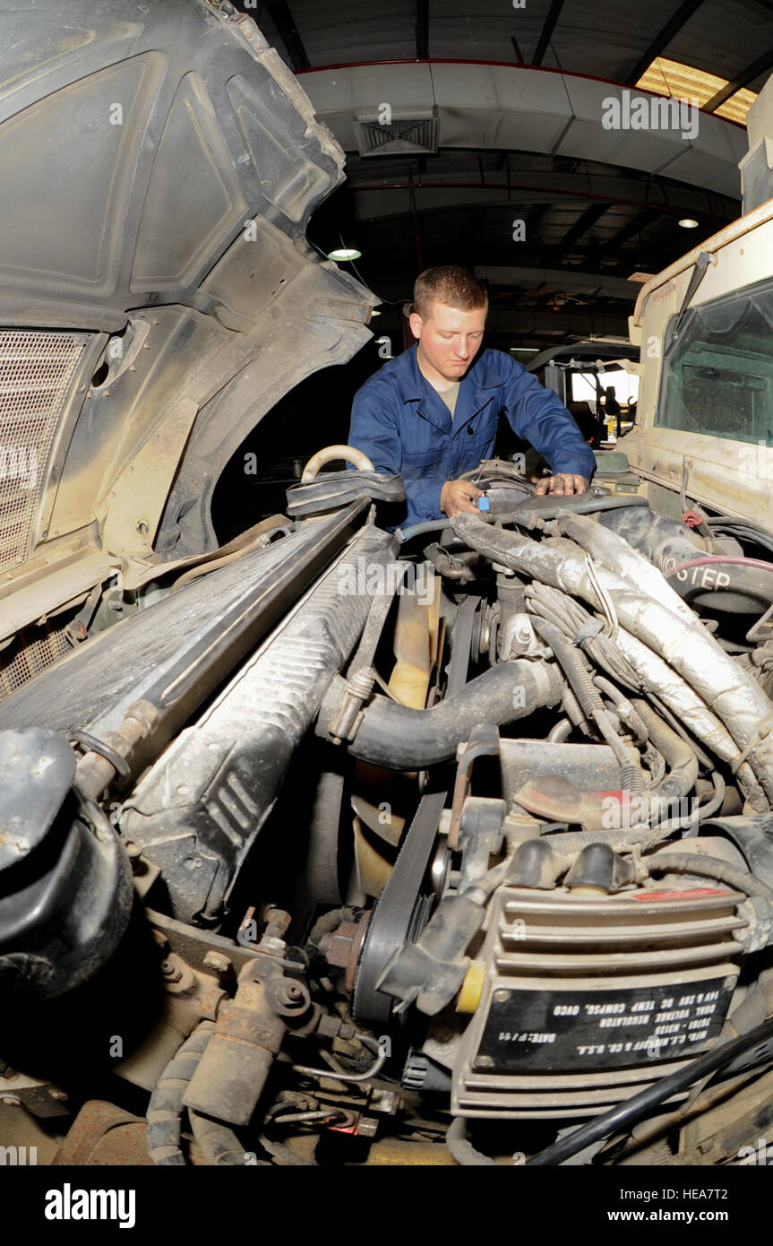 U.S. Air Force Airman 1st Class Sean Goddard, 380th Expeditionary Logistics Readiness Squadron vehicle mechanic, installs an air-line from the air filter to the intake manifold on a Humvee at an undisclosed location in Southwest Asia, June 19, 2013. The air-line will allow clean airflow to reach the vehicles engine. Goddard is native to Clinton, Iowa, and is deployed from Eielson Air Force Base, Alaska.  Staff Sgt. Joshua J. Garcia Stock Photo