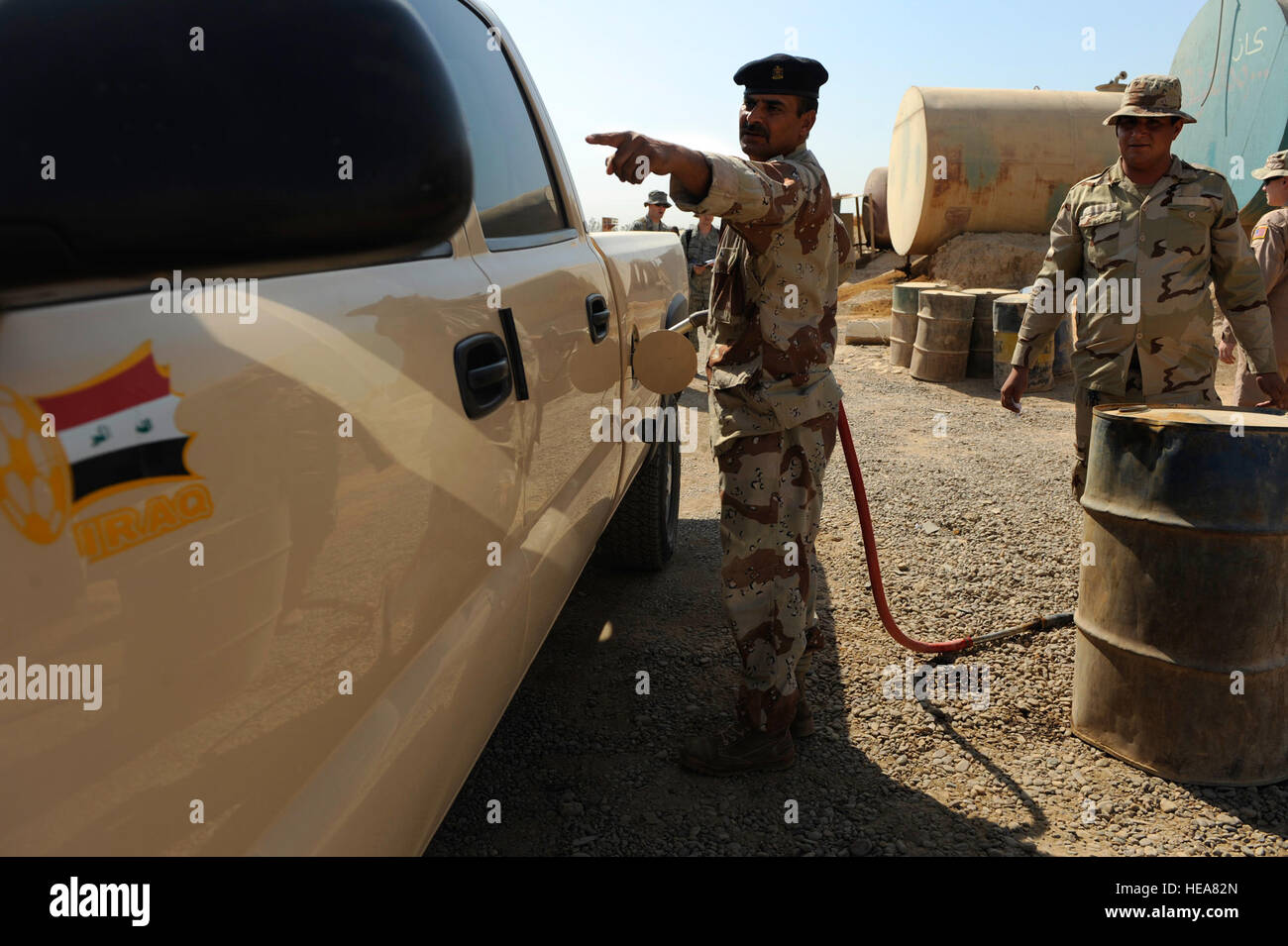 Iraqi soldiers refuel their vehicles at Camp Taji, near Baghdad, Iraq, July 11. The Iraqi fuels depot is run exclusively by the Iraqi army with some assistance from an American Airman assigned to the Logistics Military Advisor Team. Stock Photo