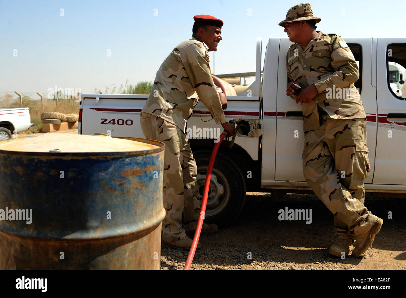 Iraqi soldiers refuel a vehicle at Camp Taji, near Baghdad, Iraq, July 11. The Iraqi fuels depot is run exclusively by the Iraqi army with some assistance from an American Airman assigned to the Logistics Military Advisor Team. Stock Photo