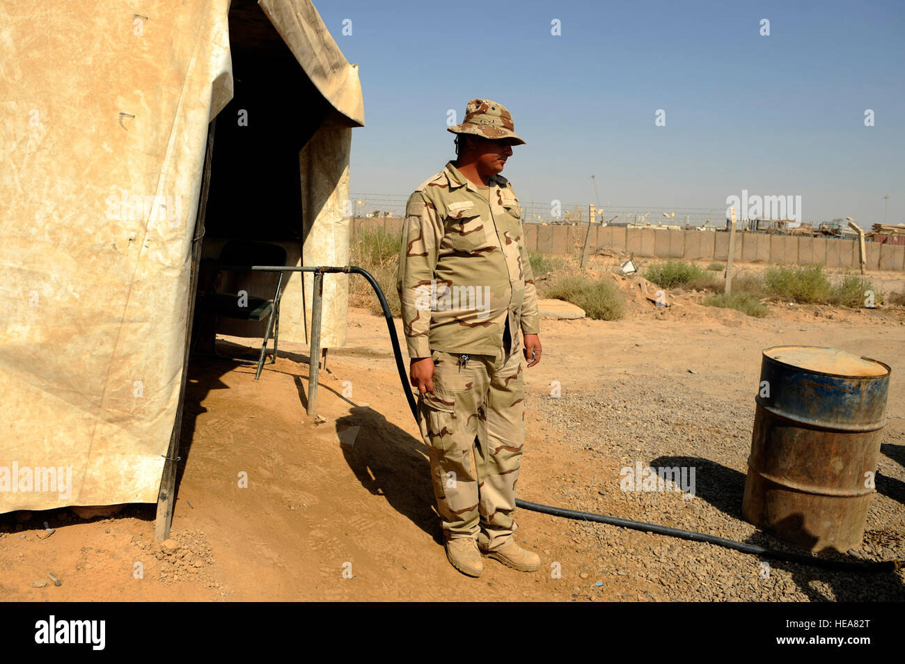 An Iraqi soldier waits to refuel a vehicle at Camp Taji, near Baghdad, Iraq, July 11. The Iraqi fuels depot is run exclusively by the Iraqi army with some assistance from an American Airman assigned to the Logistics Military Advisor Team. Stock Photo