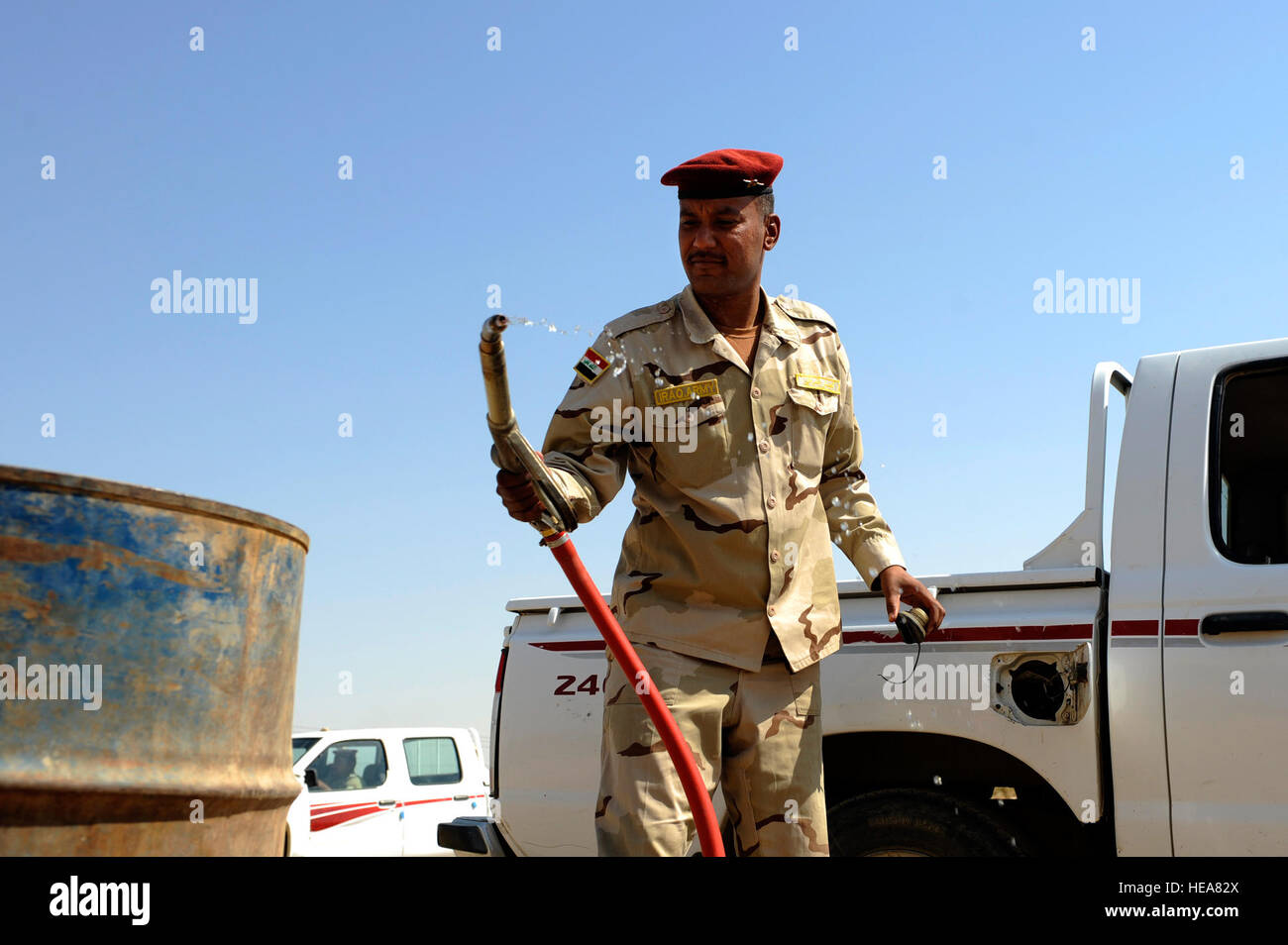 An Iraqi soldier finishes refueling a vehicle at Camp Taji, near Baghdad, Iraq, July 11. The Iraqi fuels depot is run exclusively by the Iraqi army with some assistance from an American Airman assigned to the Logistics Military Advisor Team. Stock Photo
