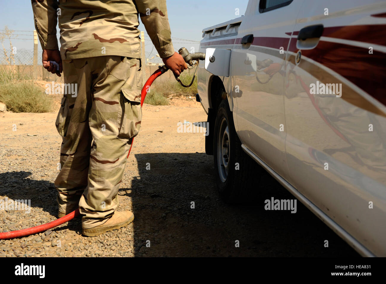 An Iraqi soldier refuels a vehicle at Camp Taji, near Baghdad, Iraq, July 11. The Iraqi fuels depot is run exclusively by the Iraqi army with some assistance from an American Airman assigned to the Logistics Military Advisor Team. Stock Photo