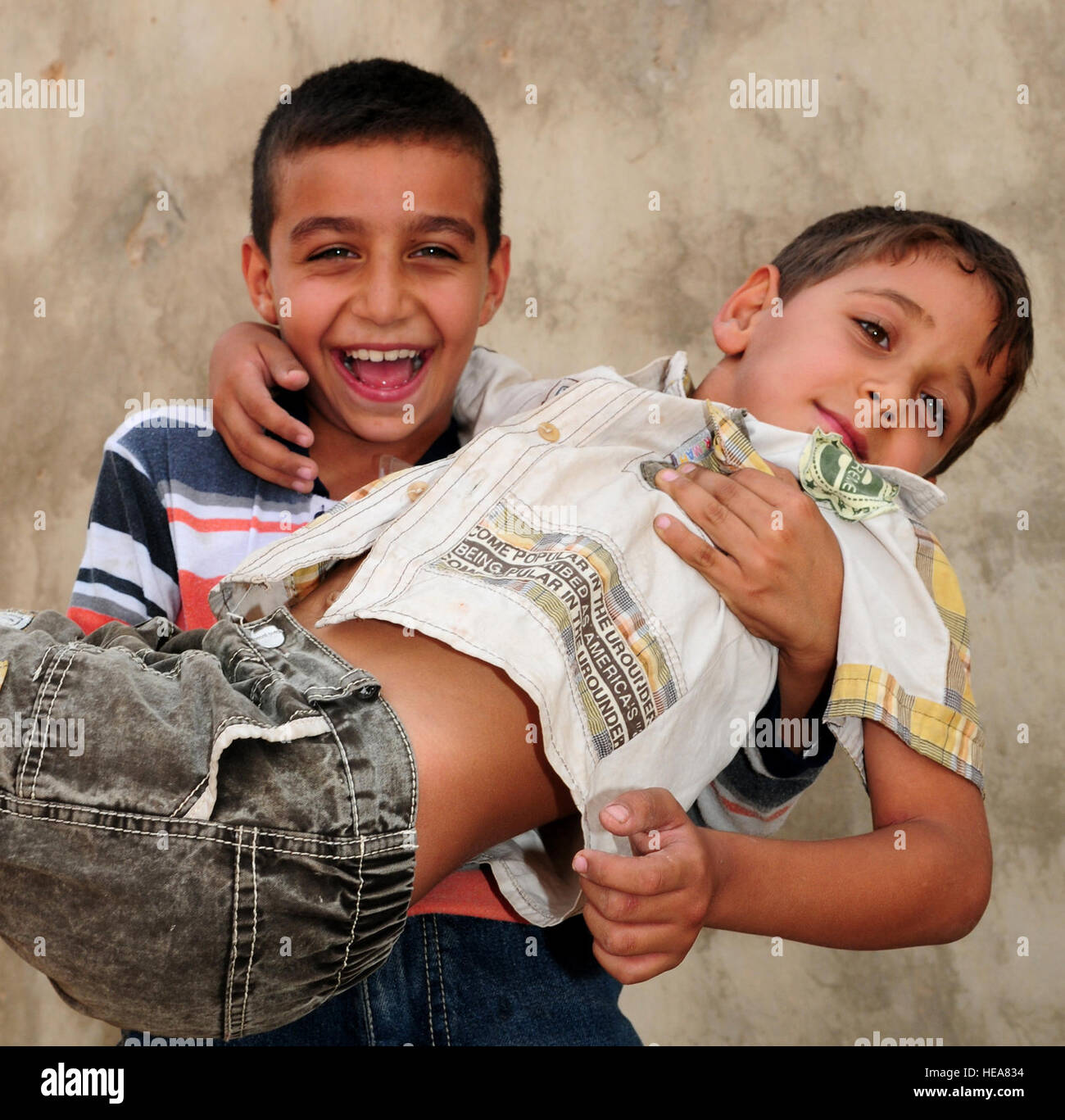 JOINT BASE BALAD, Iraq – Two Iraqi children play during Iraqi Kids Day here Oct. 10, 2009. JBB hosted 125 children, parents and officials, increasing community relations with surrounding villages. Staff Sgt. Heather M. Norris) (Released) Stock Photo