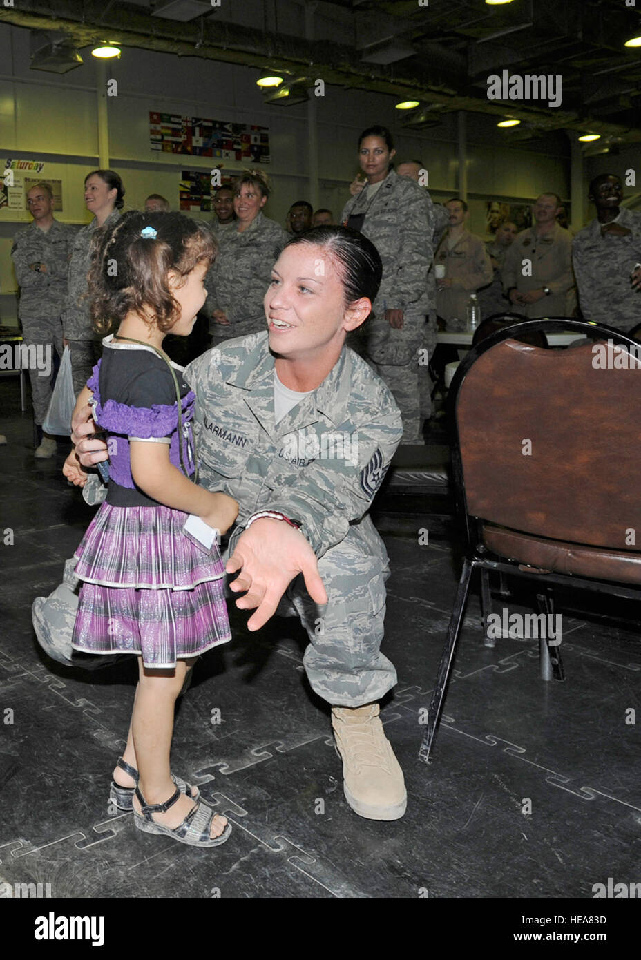 Technical Sgt. Aimee Klarmann, 332nd Expeditionary Medical Group, greets an Iraqi girl during Iraqi Kids Day at Joint Base Balad, Iraq, June 19. This was the second Iraqi Kids Day for Klarmann. Iraqi Kids Day serves as part of the ongoing base effort to spread goodwill to the local community. Over 70 children from local villages were bussed on base to play games, share culture and to have a day of fun. : Senior Airman Matthew Coleman-Foster) Stock Photo
