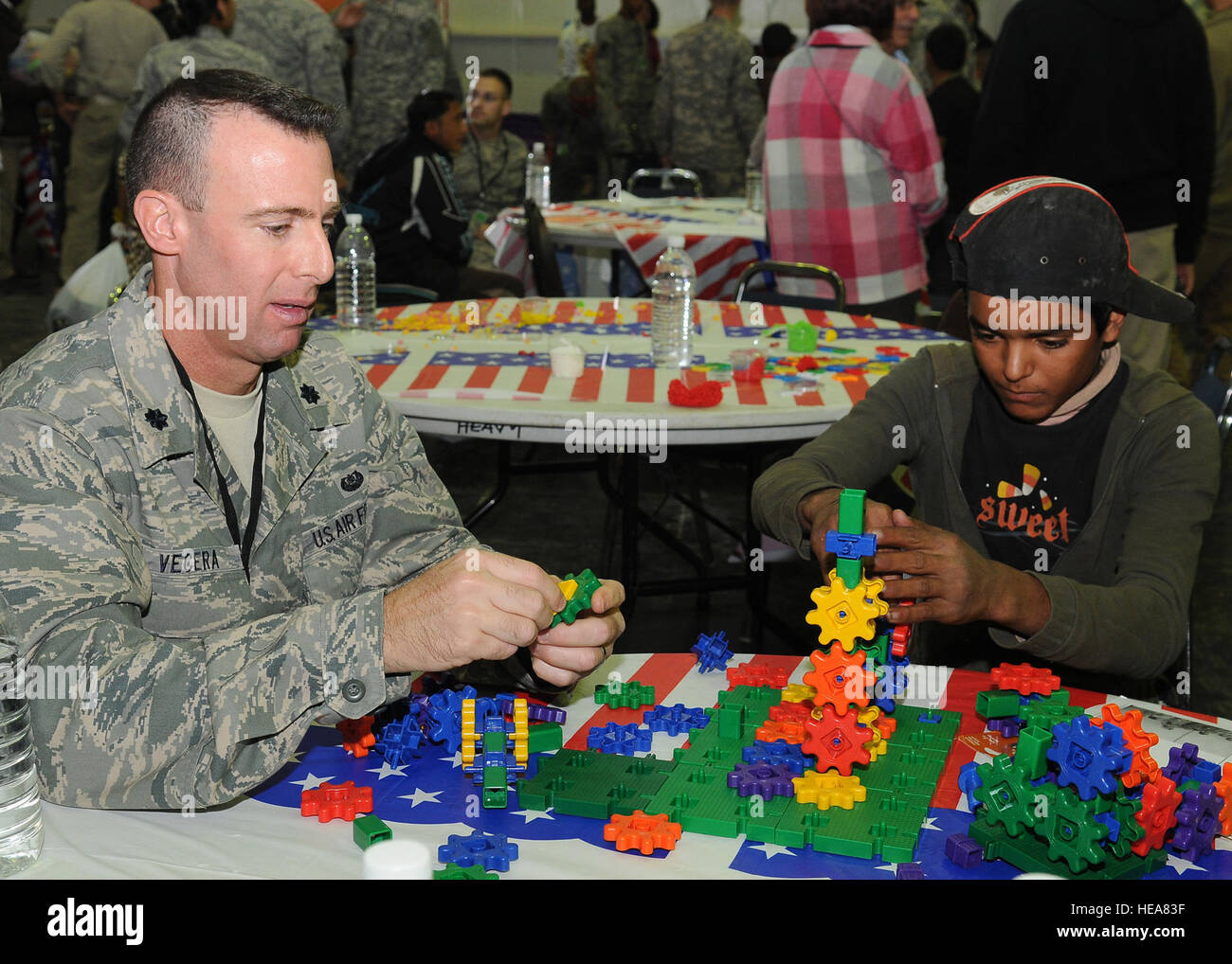 JOINT BASE BALAD, IRAQ -- Lt. Col. Michael Vecera, 332nd Air Expeditionary Wing Staff Judge Advocate, and an Iraqi youth connect pieces together to build a toy Dec. 11, 2010.  Iraqi Kids Day is held every four to six weeks and includes activities such as games, dancing and coloring. Colonel Vecera is a native of Baltimore and is deployed from Seymour-Johnson Air Force Base, N.C. (U.S. Air Force Photo/ Senior Airman Marianne E. Lane) Stock Photo