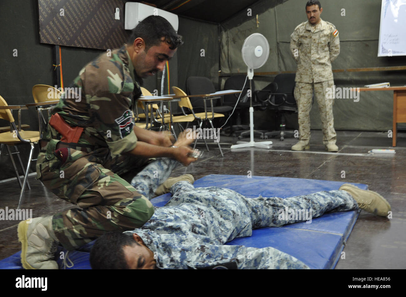 Iraqi policemen practice takedown and handcuffing techniques at the Iraqi Police Academy on