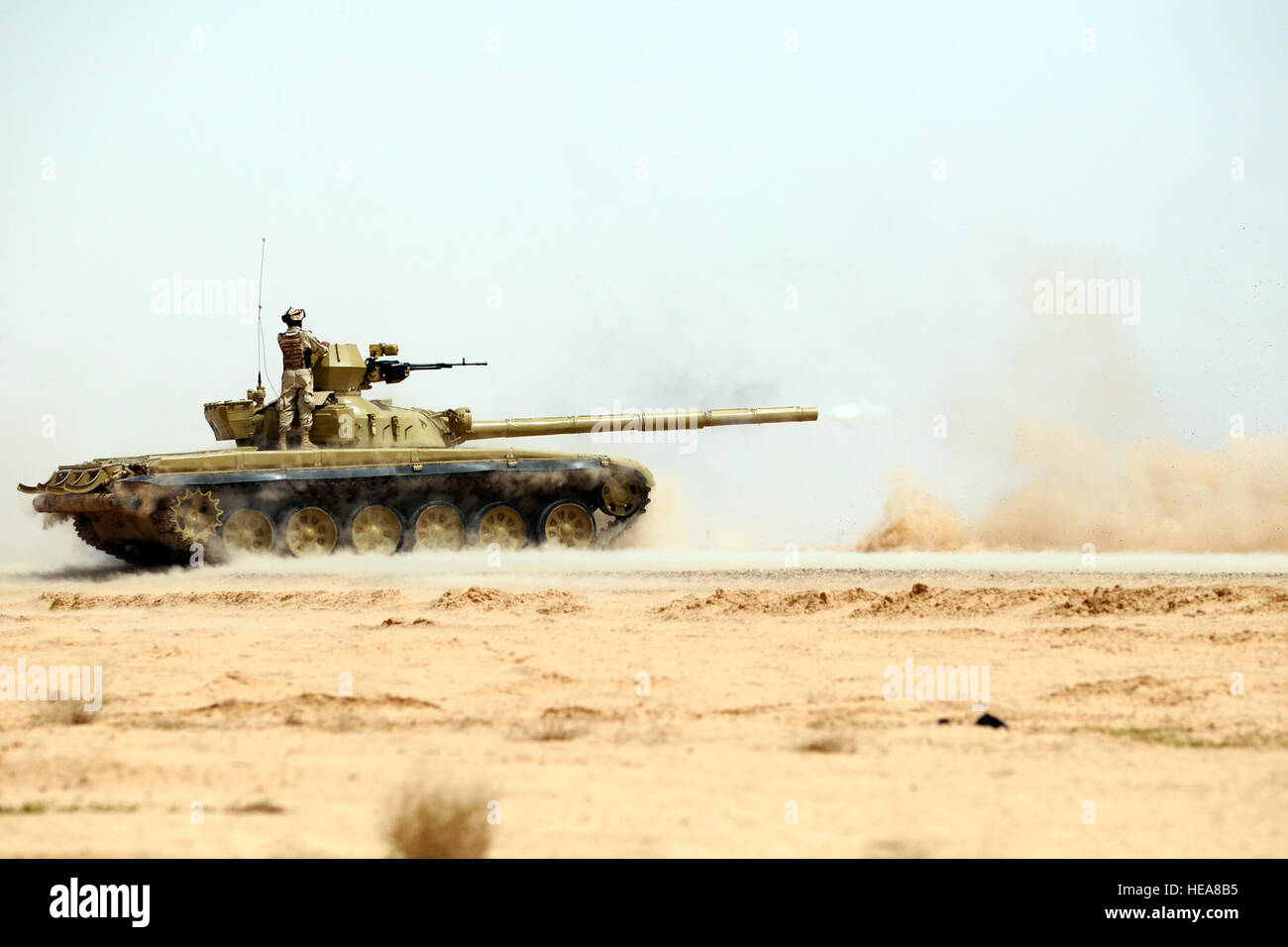 An Iraqi T-72 tank fires at targets during a partnered firing exercise with U.S. Soldiers assigned to the 3rd Battalion, 69th Armor Regiment and 9th Iraqi army at Besmaya range, Iraq, April 14, 2010. The exercise allowed Iraqi security forces to learn speed-loading and accuracy techniques.  Spc. Jared Eastman Stock Photo