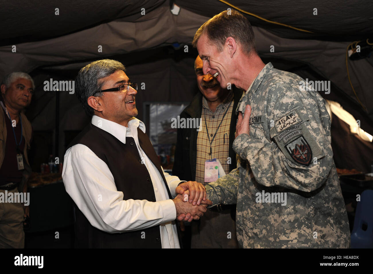 While visiting Forward Operating Base (FOB) Farah, Afghanistan, the International Security Assistance Force (ISAF) Commander, U.S. Army Gen. Stanley McChrystal, shakes hands with Farah Provincial Governor Rahool Amin, Jan. 22, 2010. Gen. McChrystal also met with the Afghan National Police (ANP) Chief, Brig. Gen. Mohammad Fagir Askar, the Farah Province Brigade Commander of the Afghan National Army (ANA), Brig. Gen. Mohammad Akram Sameh, and Samad Shams, the Commander of the National Directorate of Security for Farah Province. FOB Farah was just one of the several locations Gen. McChrystal visi Stock Photo