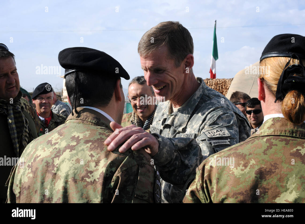During his visit to Regional Command West (RC-West), International Security Assistance Force (ISAF) Commander Gen. Stanley McChrystal laughs with Warrant Officer Mura Gianpaolo, a member of Italian Task Force South stationed at Forward Operating Base (FOB) Farah, Afghanistan, Jan. 22, 2010. Gen. McChrystal visited several bases and outposts in RC-West to speak with ISAF leaders and representatives of the provincial government, including Farah Provincial Governor Rahool Amin. Stock Photo