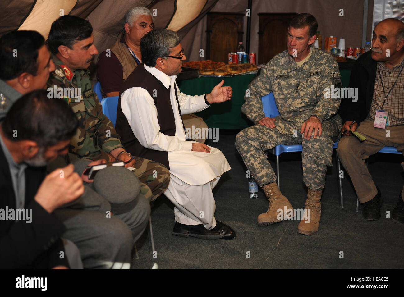In a tent located on Forward Operating Base (FOB) Farah, Gen. Stanley McChrystal, the International Security Assistance Force (ISAF) Commander, meets with Farah Province government officials and coalition leaders, Jan. 22, 2010. Among the many topics discussed, Farah Provincial Governor Rahool Amin said, “If we compare Farah to a couple of years ago, we have a lot of achievements here. It didn’t come by force; it didn’t come by raising the Army, too many bullets or fighting. The achievements came as a result of the trust among us and us working together as a team.” Stock Photo