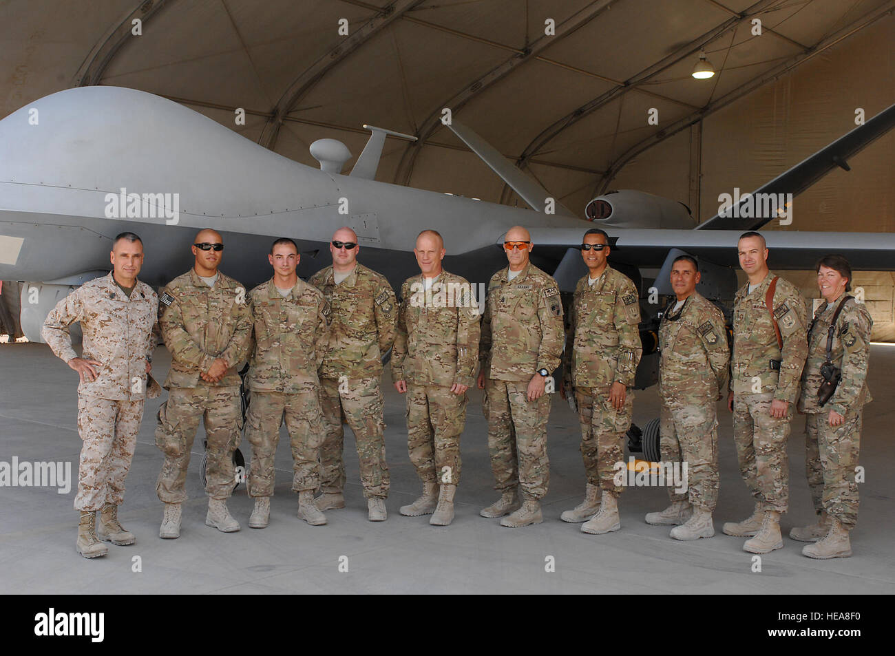 U.S. Marine Corps Sgt. Maj. James Booker, International Security Assistance Force and United States Forces-Afghanistan senior enlisted leader, and U.S. Army Command Sgt. Maj. Scott Schroeder, ISAF Joint Command sergeant major, pose for a group photo with members of the 451st Expeditionary Aircraft Maintenance Squadron during a visit to Kandahar Airfield, Afghanistan Sept. 23, 2013. The two enlisted leaders visited KAF in an effort to understand the missions of the base and meet with different service members.  Senior Airman Jack Sanders) Stock Photo
