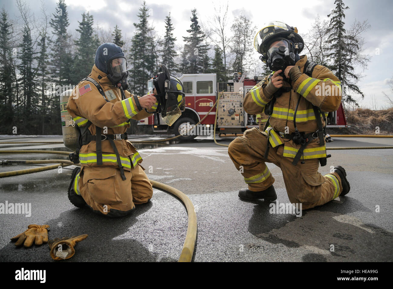 U.S. Air Force fire protection specialists, assigned to the 673rd Civil Engineer Squadron, don