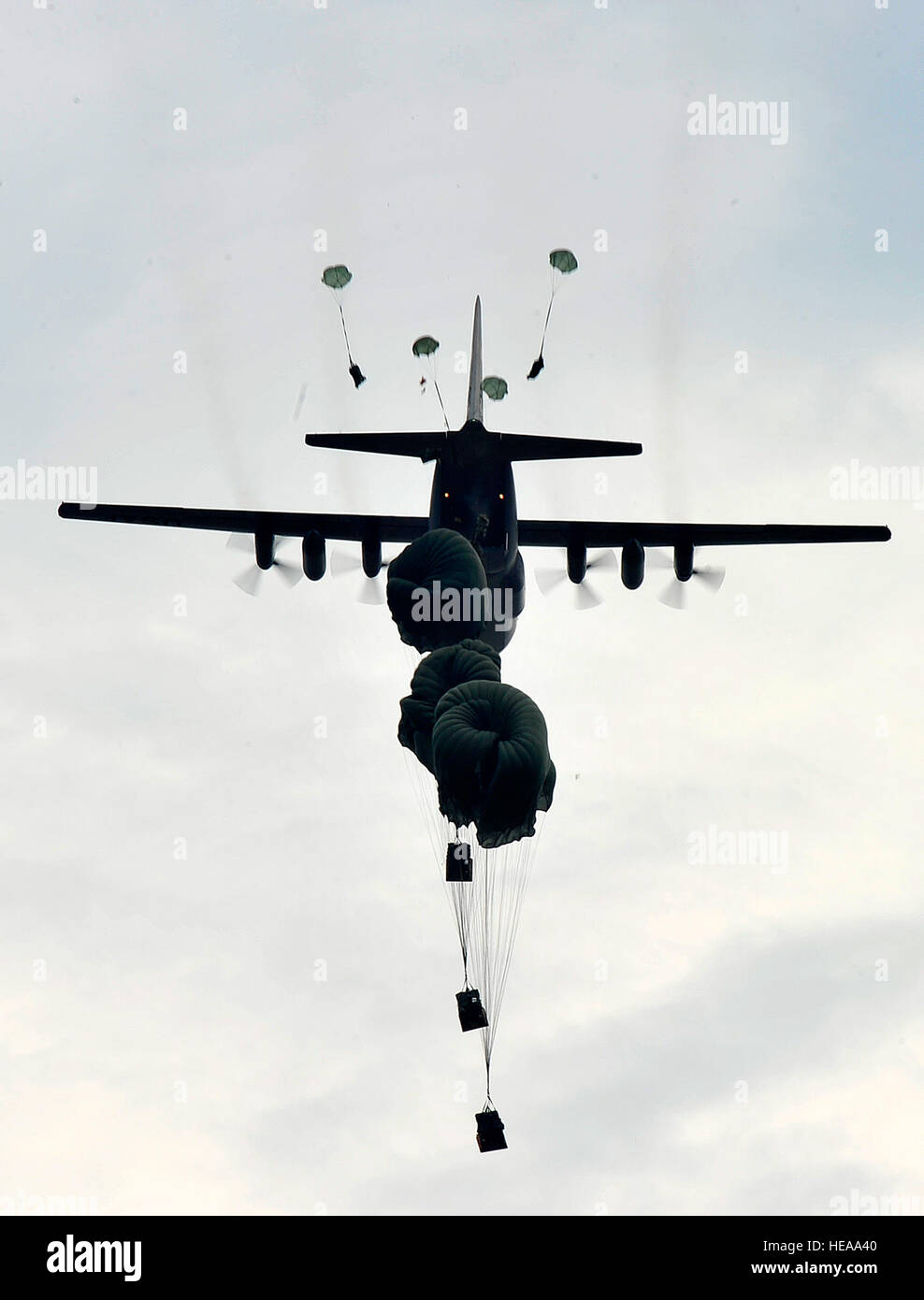 U.S. Air Force C-130 Hercules drops equipment belonging to the U.S. Army's 82nd Airborne Division onto Luzon drop zone during a training mission during Joint Operations Access Exercise 12-02 at Mackall Army Airfield , N.C., June 4, 2012. JOAX is a two-week forcible entry and ground combat exercise to prepare Air Force and Army service members to respond to worldwide crises and contingencies. Stock Photo