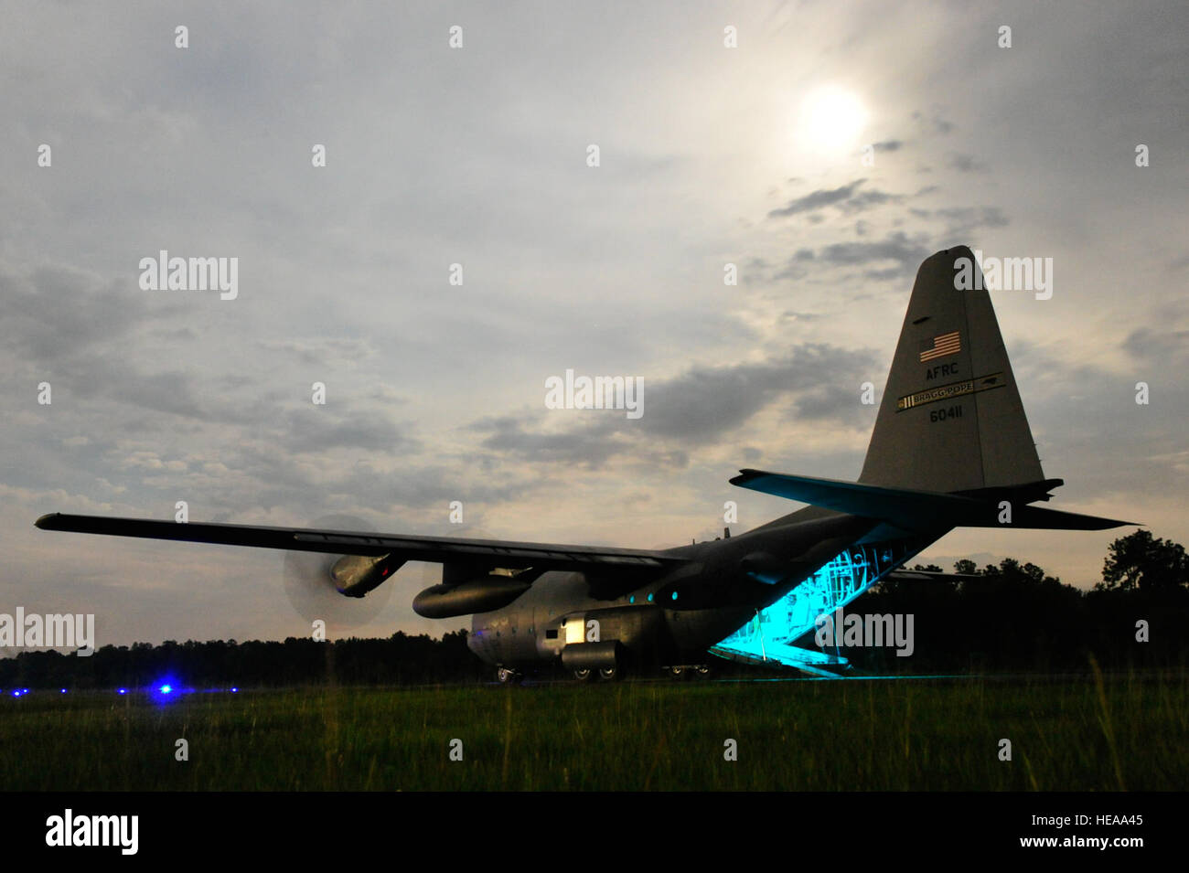 A U.S. Air Force C-130J Hercules waits for cargo to be offloaded under blackout conditions at an intermediate staging base established at Mackall Army Airfield, N.C. during Joint Operational Access Exercise 12-02, June 4, 2012.  JOAX is a two-week exercise to prepare Air Force and Army service members to respond to worldwide crises and contingencies. Stock Photo
