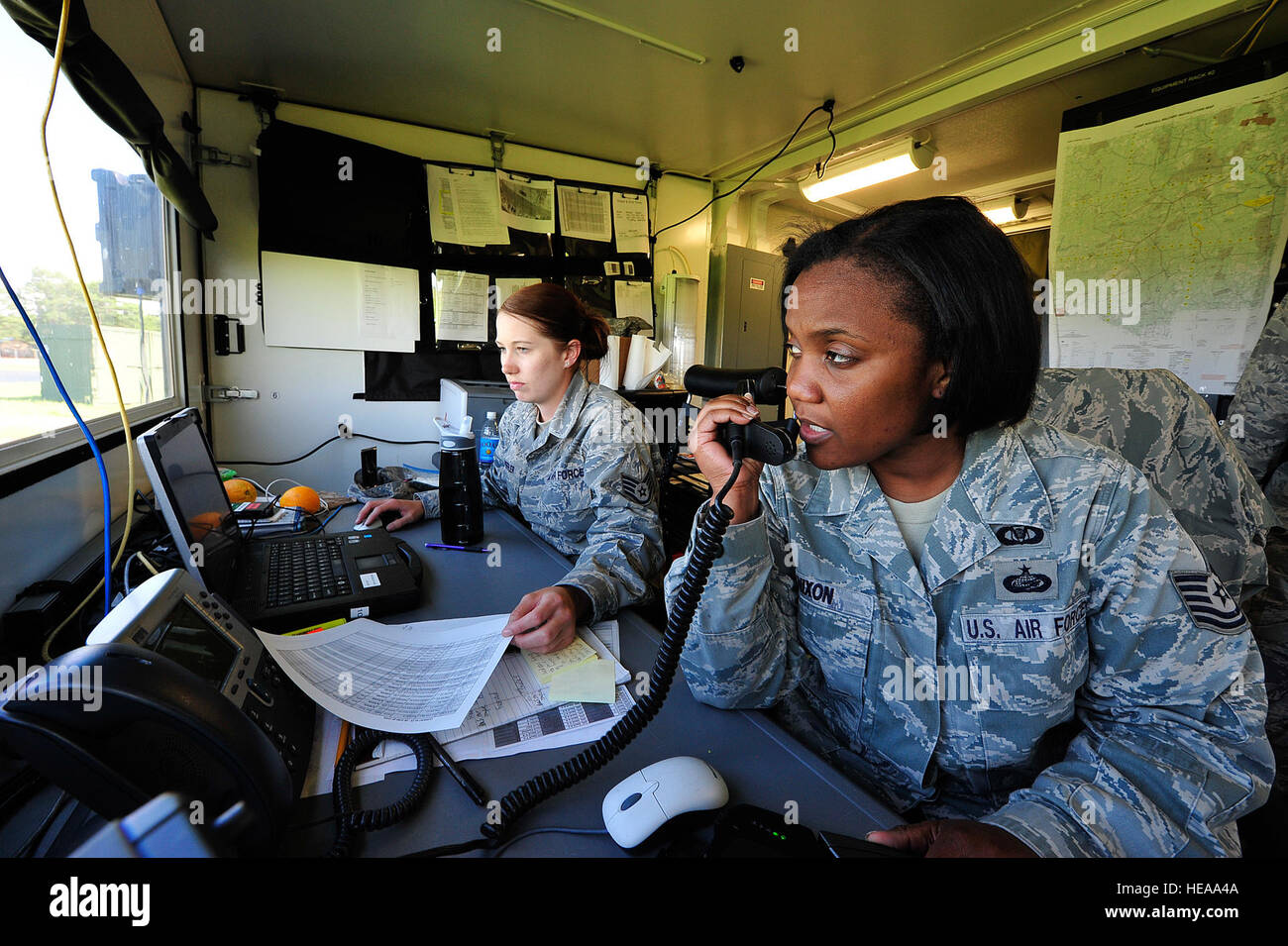 From left, U.S Air Force Staff Sgt. Nicole Shreffler and Tech. Sgt. Haniyyah Nixon, command post controllers from the 621st Contingency Response Wing, at Joint Base McGuire-Dix-Lakehurst, N.J. provide air mobility logistics support at Mackall Army Airfield, N.C. during Joint Operational Access Exercise 12-02, June 6, 2012.  The JOAX is a two-week forcible entry and ground combat exercise to prepare Air Force and Army service members to respond to worldwide crises and contingencies. Stock Photo