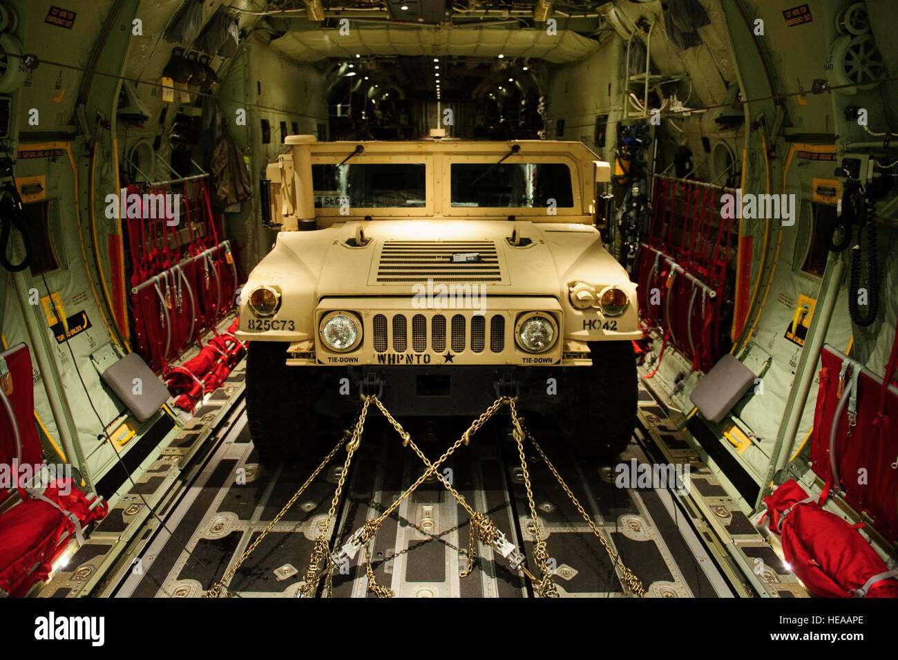 An U.S. Army Humvee is strapped onto C130J Super Hercules for