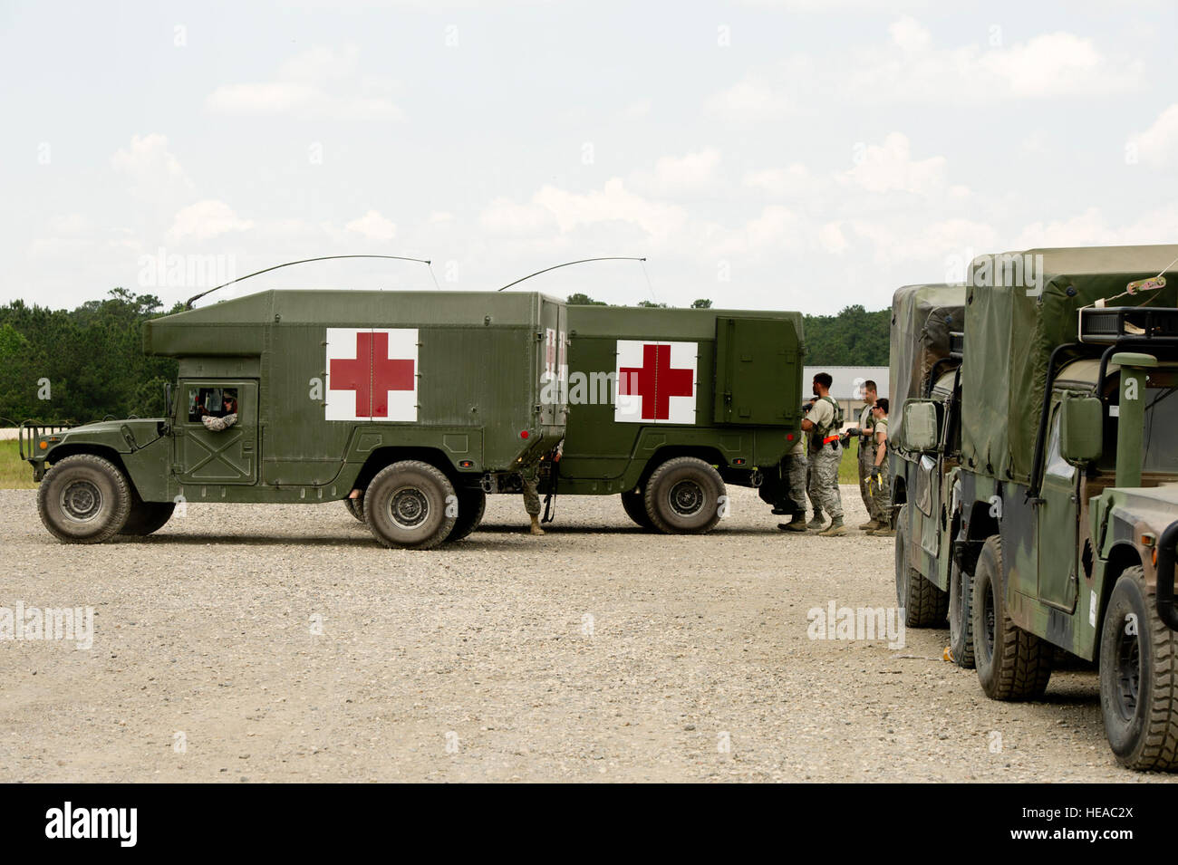 U.S. Army M997 High Mobility Multi-Purpose Wheeled Vehicle Ambulances sit in front of the Mobile Aeromedical Staging Facility before delivering simulated patients during the joint service field exercise JRTC 12-06 at the Joint Readiness Training Center, Fort Polk, La., May 07, 2012. JRTC is designed to prepare and educate U.S. military Service members for deployments to the Middle East.  Staff Sgt. Matthew Smith Stock Photo