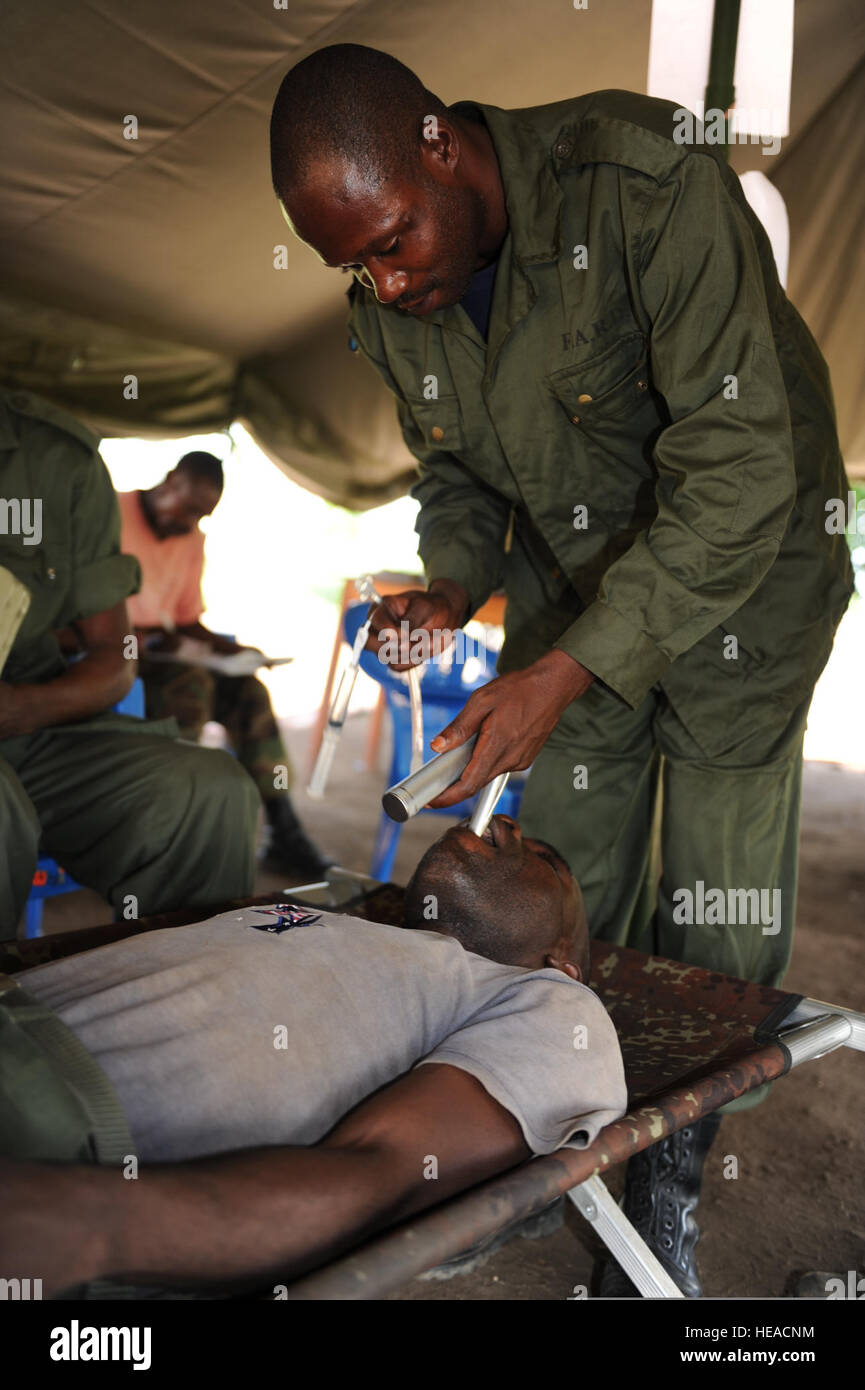 Dr. Kasole Castro, right, demonstrates how to perform an oral tracheal intubation on a Congolese Light Infantry Battalion medic at Camp Base in Kisangani, Congo, May 6, 2010. Medical care and first aid training were part of Operation Olympic Chase, an operation led by U.S. Africa Command.  Staff Sgt. Jocelyn A. Guthrie Stock Photo