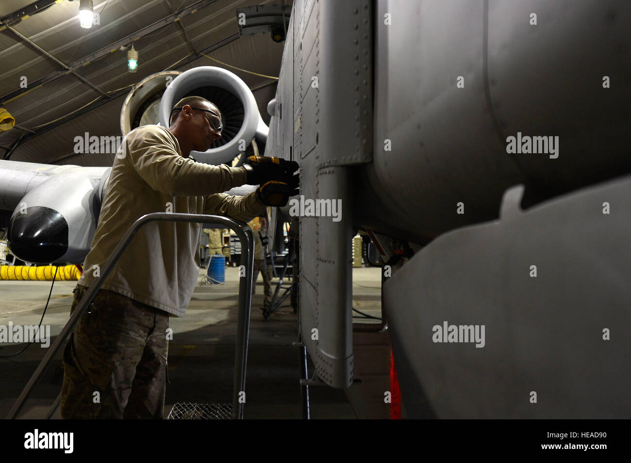 U.S. Air Force Senior Airman Jason Stanley, 455th Expeditionary Maintenance Squadron A-10 Thunderbolt II faze technician, performs maintenance on an A-10 Thunderbolt II at Bagram Air Field, Afghanistan, Dec. 30, 2013. The A-10 Thunderbolt II provides close-air support for troops on the ground. Stanley is deployed from the 476th Fighter Group from Moody Air Force Base, Ga., and a native of Canton, Ga.  Senior Airman Kayla Newman Stock Photo