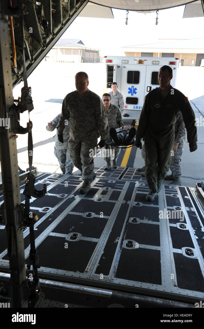 U.S. Air Force 1st Lt. Pete Traylor, left, with the 81st Inpatient Operations Squadron, and Maj. Jonathan Ellis, with the 81st Surgical Operations Squadron, help carry a mock patient aboard a C-130 Hercules aircraft during air evacuation training March 14, 2013, at Keesler Air Force Base, Miss. The training was intended to provide experience in configuring C-130s for patient transport. Airmen with the 81st MDG, 81st AMDS, 81st Medical Operations Squadron and 53rd Weather Reconnaissance Squadron took part in the event.  Kemberly Groue Stock Photo