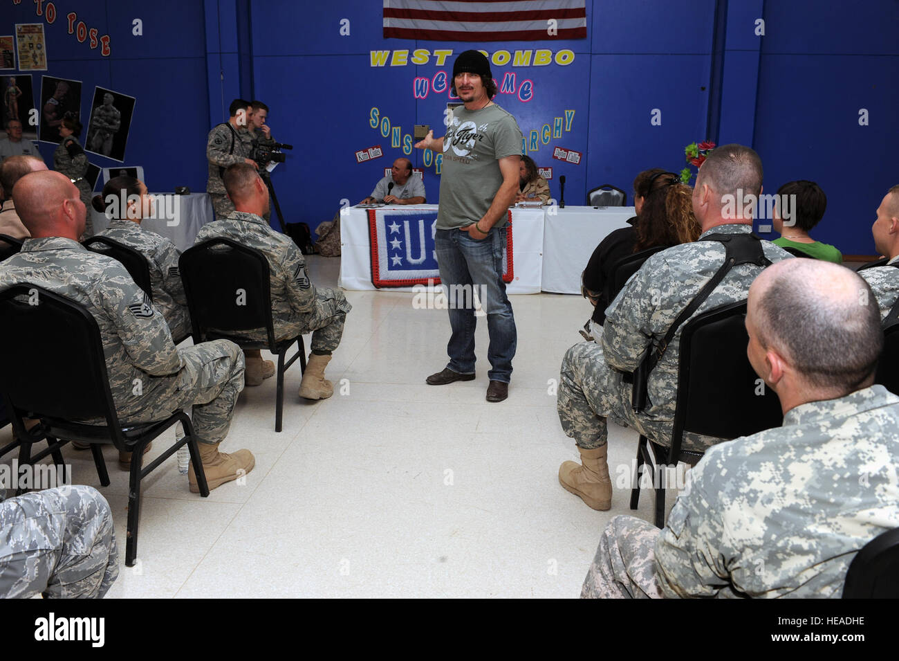 Kim Coates, a cast member of Sons of Anarchy, speaks to military personnel prior to a meet and greet event at Joint Base Balad, Iraq, March 15, 2010. Four cast members from the hit television show are touring bases throughout Southwest Asia to show their appreciation and provide a morale boost for deployed personnel.  Master Sgt. Linda C. Miller Stock Photo