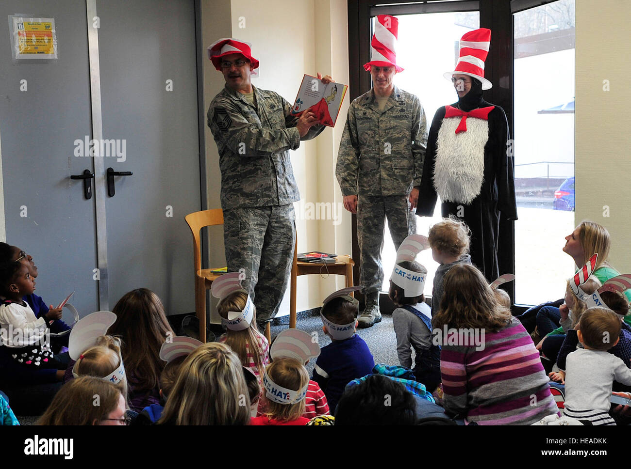 Chief Master Sgt. Steven Mandell, 86th Force Support Squadron superintendent, reads Dr. Seuss’s “Green Eggs and Ham” to children and their parents during Read Across America, March 5, 2015, at Ramstein Air Base, Germany. The event consisted of story-time, snacks and free books for the children. Airman 1st Class Larissa Greatwood) Stock Photo