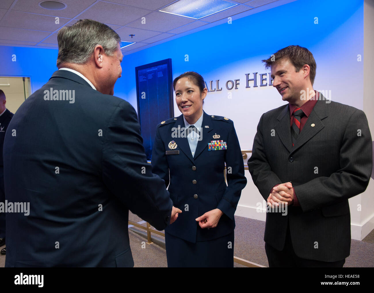 Secretary of the Air Force Michael Donley (left) congratulates Maj. Laura DeJong after she was presented the Lance P. Sijan USAF Leadership Award by Air Force Chief of Staff Gen. Norton Schwartz during a ceremony in the Pentagon's Hall of Heroes, April 6, 2012, Washington, D.C. The Sijan Award was created in 1981 to recognize individuals who demonstrate the highest qualities of leadership both in and out of uniform. Sijan, was an Air Force Academy graduate. At the time of his death, he was an Air Force captain and fighter pilot. He was shot down during a mission in Vietnam and later died while Stock Photo