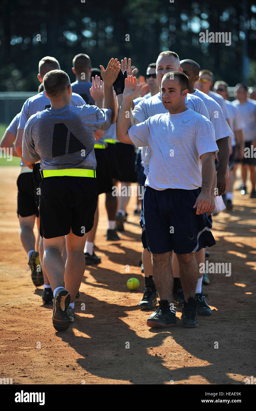 U.S. Army soldiers and U.S. Air Force airmen high-five each other after finishing a softball game against one another during the 20th Mission Support Group Warrior Challenge, Shaw Air Force Base, S.C., Sept. 6, 2013. The 20th MSG Warrior Challenge, a day-long event meant to boost morale between airmen and soldiers, included softball, tug of war, a watermelon eating contest and other events to build camaraderie.   Airman 1st Class Jensen Stidham Stock Photo