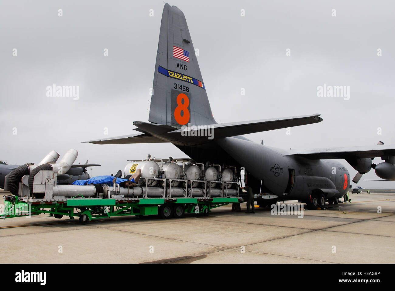 Air National Guard personnel install a Modular Airborne Fire Fighting System on a C-130 Hercules at Charlotte, North Carolina, preparing aircraft and crews for wildfire suppression operations in Northern California. Stock Photo