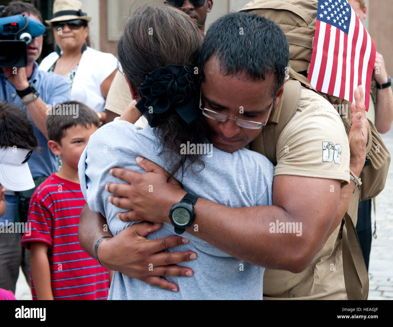 Staff Sgt. Angel Montes hugs Maj. David Gray's mother after his arrival to Arlington National Cemetery with 'Delta Flight' tactical air control party specialists from 13th Air Support Operations Squadron, Fort Carson, Colo., Aug. 8, 2103. 'DG' 140 is a 140 mile memorial ruck march for Gray, beginning at the Casualty Reception Center at Dover Air Force Base to Gray's headstone at Arlington National Cemetery Aug. 4-8. Gray was killed in action outside of combat outpost Fiaz and was posthumously awarded the Bronze Star Medal and Purple Heart.   Senior Airman Carlin Leslie) Stock Photo