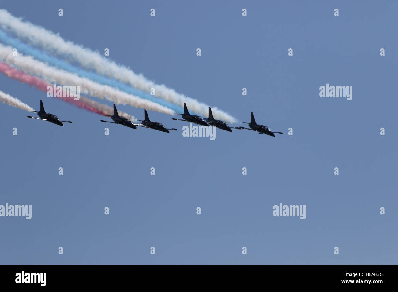 Members of the Patriots Jet Team fly in formation over the flight line ...