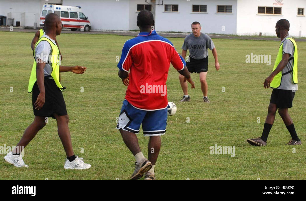 Michigan National Guard 1st Lt. Jeremiah Aberlich, Operation Onward Liberty communications adviser, competes in a mentor-mentee soccer match with Armed Forces of Liberia soldiers at Barclay Training Center, Oct. 31, 2013. The Michigan Nation Guard entered a partnership with Liberia in 2009 as part of the National Guard's State Partnership Program. Aberlich, a Warren, Mich., resident, is among 14 Guardsmen deployed with OOL.  Master Sgt. Brian Bahret) Stock Photo