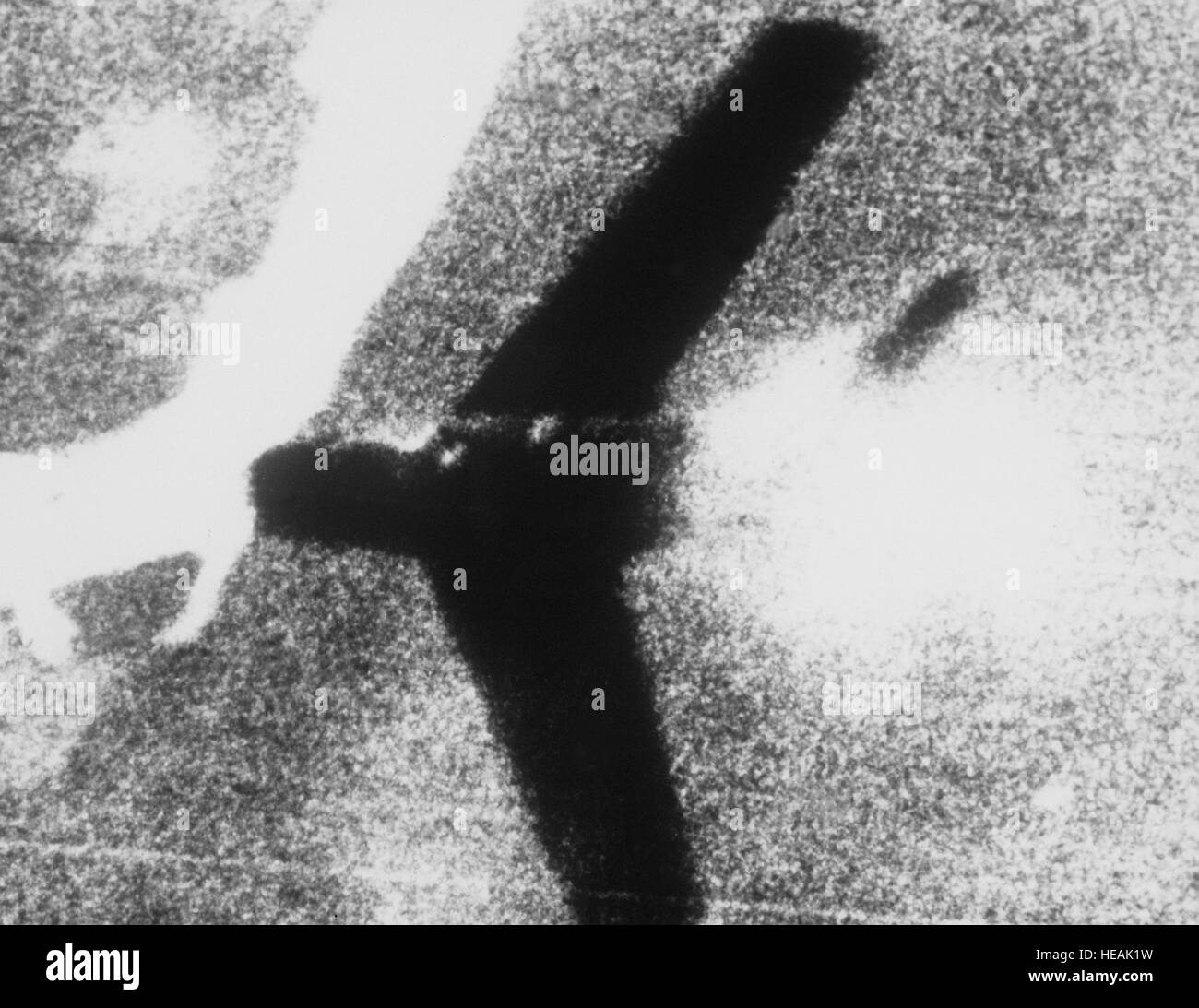 Fifth Air Force, Korea--Smoke pours from a swept-wing Russian built MiG-15 as bullets spatter from the blazing machine guns of a U.S. Air Force F-86 'Sabre' jet pilot.  Photographs, such as this, printed from actual gun camera film, plus written statements of jet pilots who witness the 'kill' must be evaluated before official confirmation or credit may be given.  The whie ribbon in the photograph is a river somewhere below MiG Alley. AIR AND SPACE MUSEUM#:  86338 AC Stock Photo