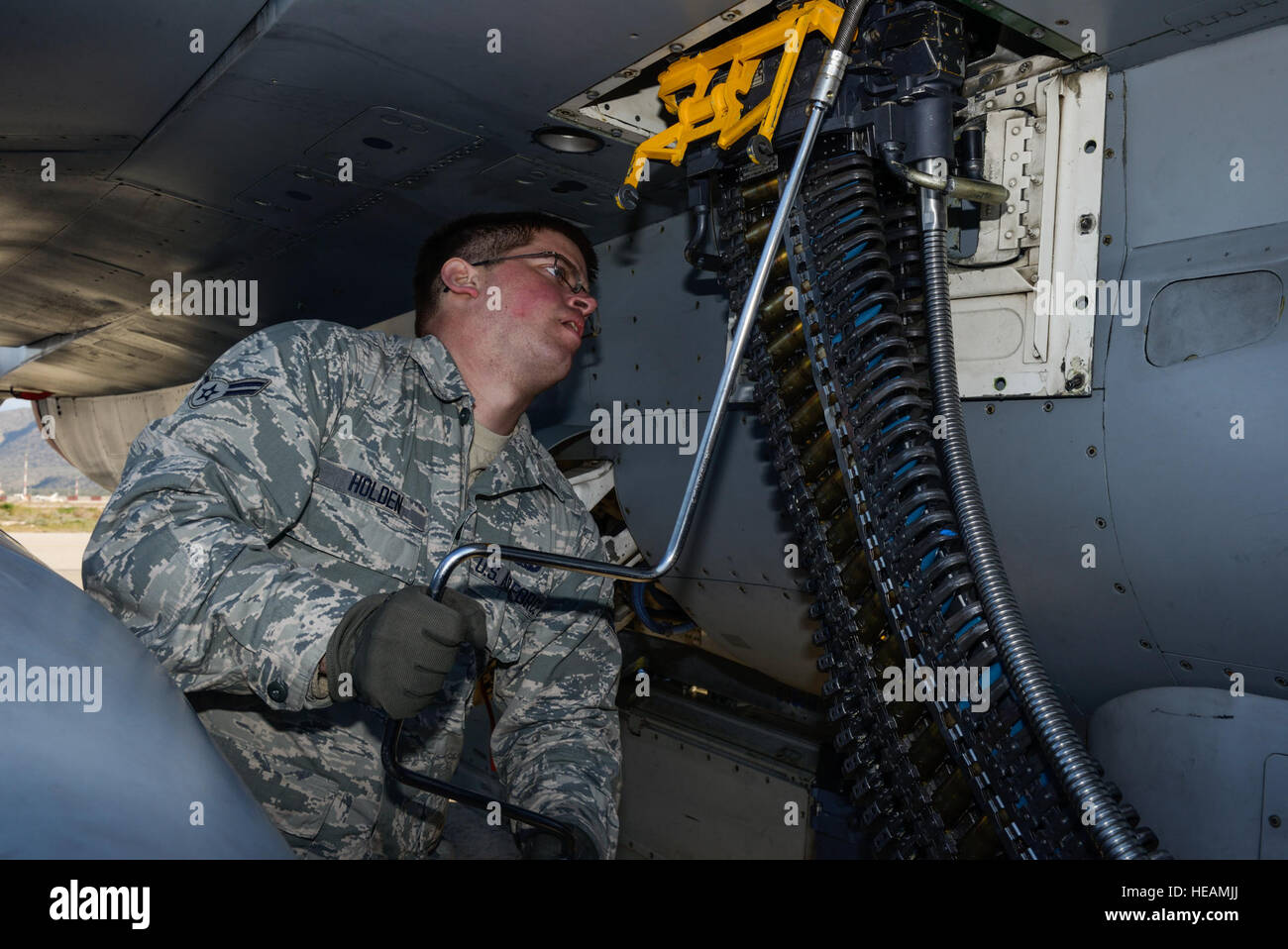 U.S. Air Force Airman 1st Class Austin Holden, a weapons load crew member assigned to the 480th Expeditionary Fighter Squadron, Spangdahlem Air Base, Germany, uses a universal ammunition loading system to load 20 mm practice rounds into an F-16 Fighting Falcon fighter aircraft during a flying training deployment on the flightline at Souda Bay, Greece, Jan. 29, 2016.The inert munitions used during the FTD simulate real conditions the 480th EFS pilots might use when engaging enemy forces.  Staff Sgt. Christopher Ruano Stock Photo