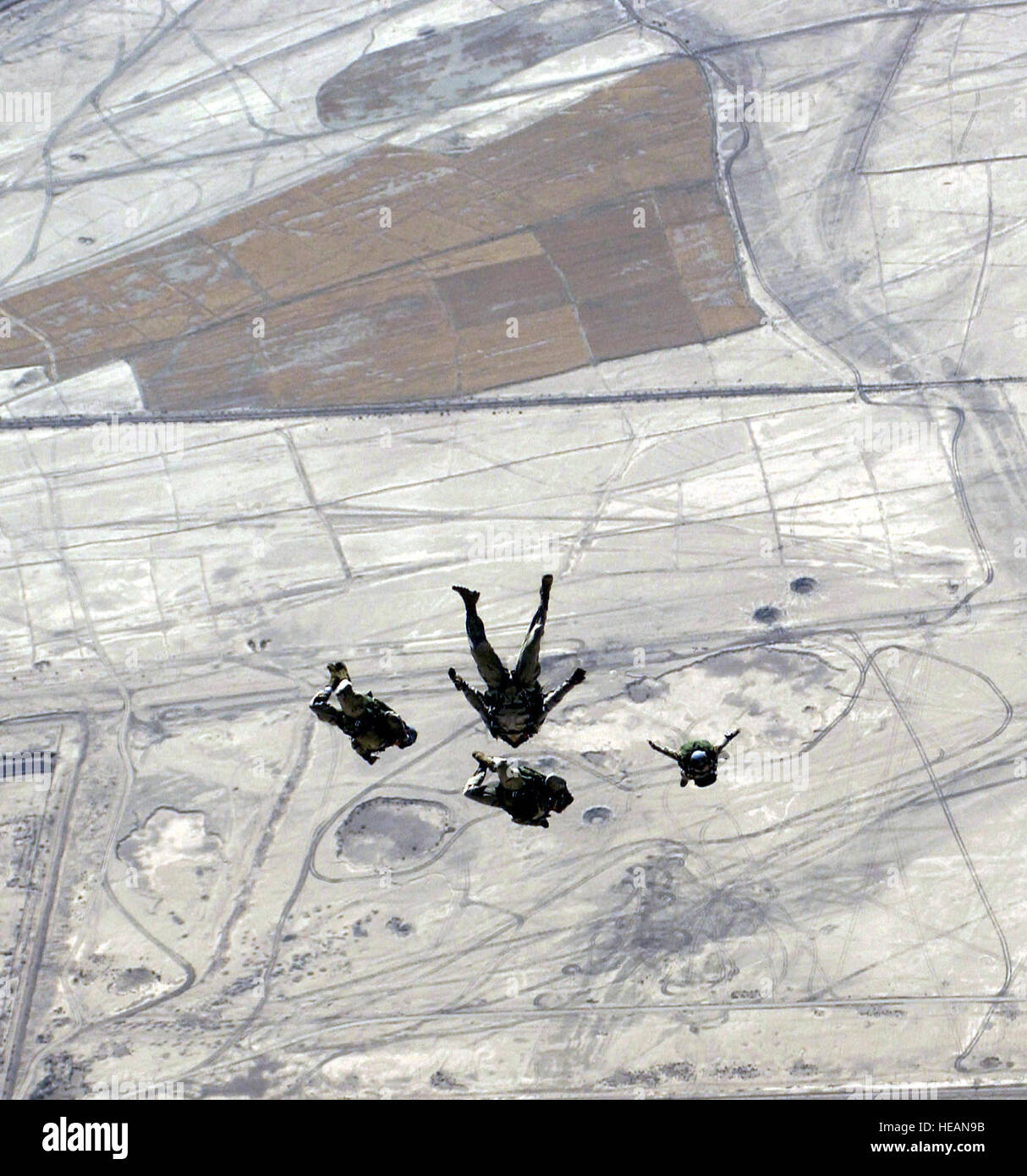 US Air Force Reserve Pararescuemen assigned to the 301st Rescue Squadron, perform a high altitude low opening parachute jump over Tallil Air Base, Iraq, during Operation Iraqi Freedom. Staff Sgt. Shane Cuomo) Stock Photo