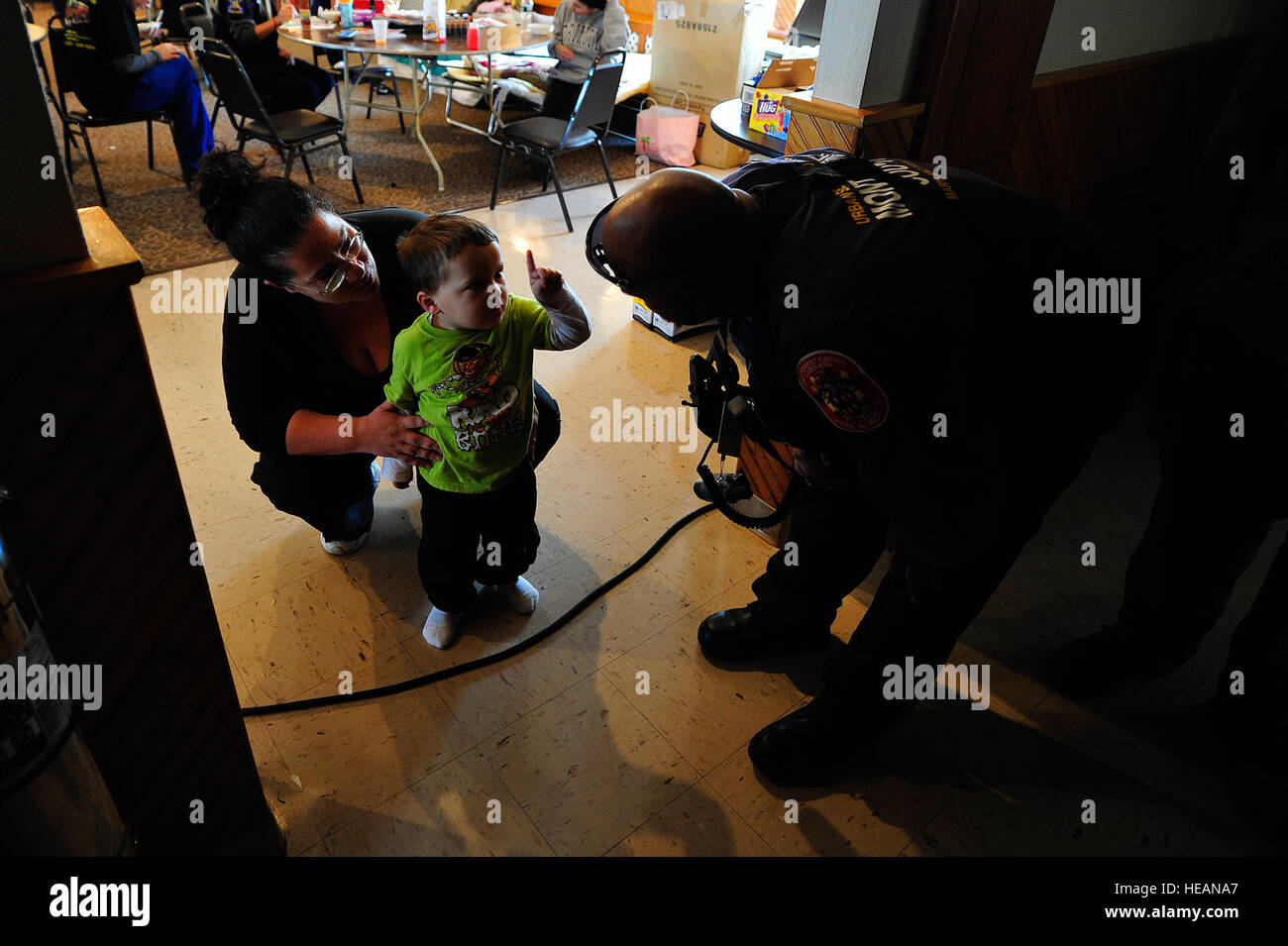 Rich Tatum, a rescue specialist with the Maryland Task Force One urban search and rescue team, asks a little boy how old he is at a firehouse in East Rockaway, N.Y., Nov. 4, 2012. Stock Photo