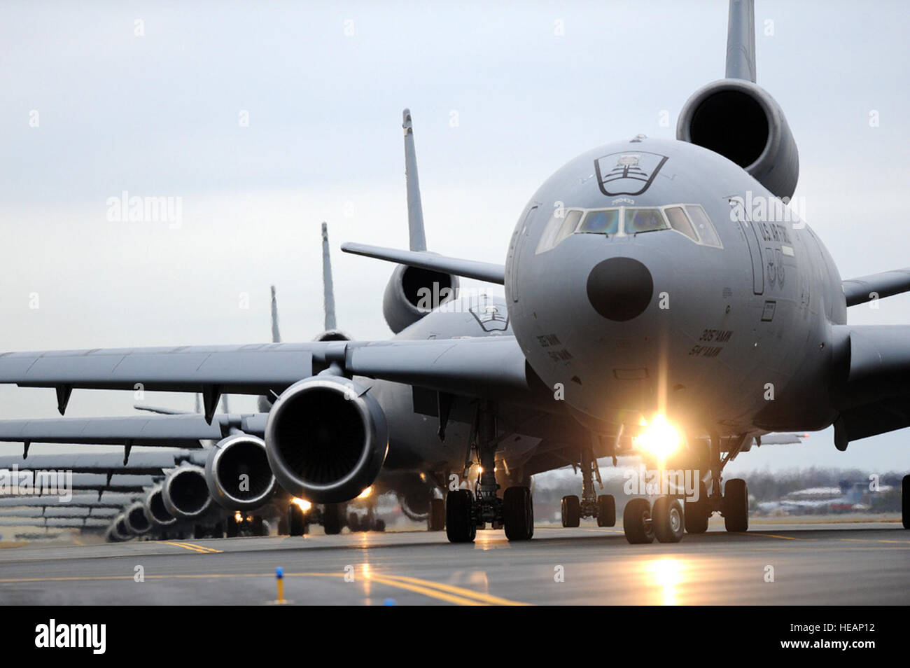 Eight KC-10 Extenders taxi out to the runway Dec. 20 here in preparation for an ‘Elephant Walk’ exercise. An ‘Elephant Walk’ is a fundamental training element when preparing for Global Strike Missions. This was the first ‘Elephant Walk’ in nearly five years, with the 305th Air Mobility Wing launching all 12 KC-10 Extenders on the ramp within in a 30-minute time period. Members of the 32nd and 2nd Air Refueling Squadrons, as well as members from the 514th Air Mobility Wing, participated in the Employment Defense and Global Engagement exercise.  Russell Meseroll) Stock Photo