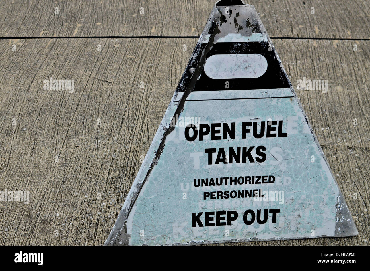 An open fuel tank sign sits outside the fuel cell hangar at Hurlburt Field, Fla., Feb. 21, 2014. During open tank maintenance, the area is cordoned off to create a controlled area free of spark producing and  non-intrinsically safe equipment.(U.S. Air Force Photo/Staff Sgt. John Bainter) Stock Photo