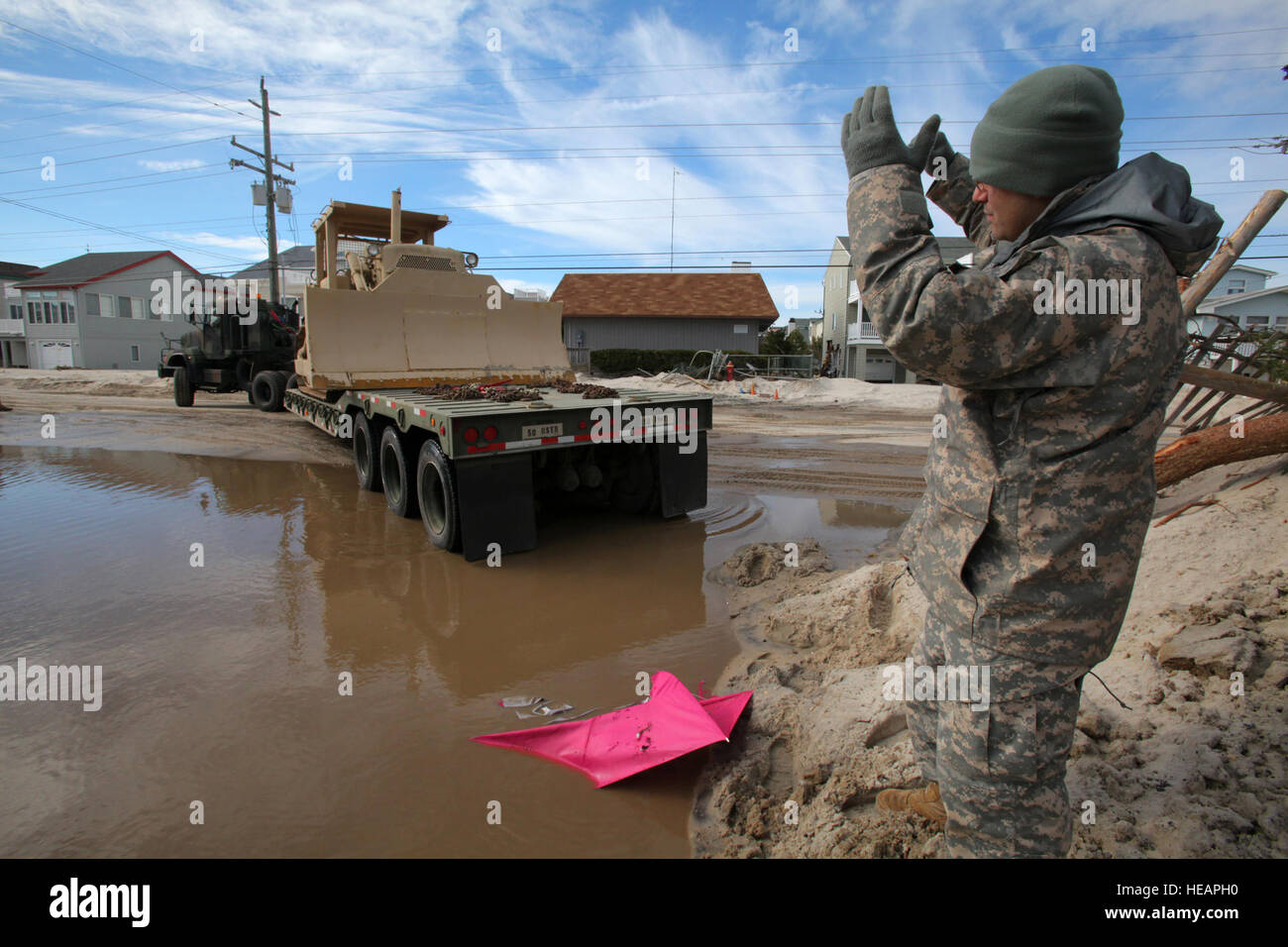 Sgt. Christopher Luisi guides a M916A2 truck tractor light equipment