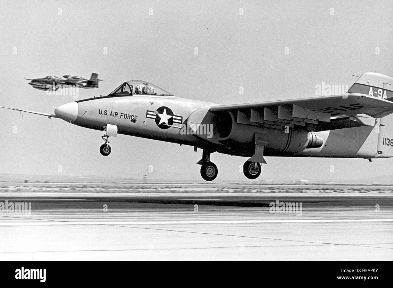 Northrop A-9A just before touchdown on its first flight. Note the Cessna A-37 chase plane in the background. (U.S. Air Force photo) Stock Photo