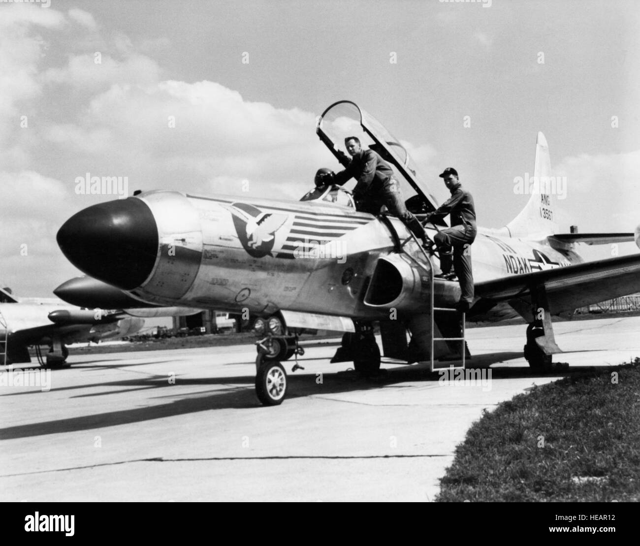 U.S. Air Force personnel assigned to the 119th Fighter Wing 'Happy Hooligans', North Dakota Air National Guard, Robert Groom and Neil Modin, photographed with their F-94 A/C Starfire aircraft at Hector Field, North Dakota. The 'Happy Hooligan' pilots flew the F-94 A/C Starfire aircraft from 1954-to-1960. (A3604) (U.S. Air Force Photo) (Released) Stock Photo