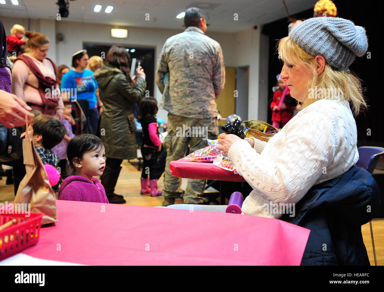 A balloon artist creates balloon animals for children during the “Frozen” family event, Jan. 26, 2015 at the Community Center on Ramstein Air Base, Germany. Children and their families had the opportunity to meet one of the movie’s characters, Olaf, as well as make arts and crafts. Airman 1st Class Larissa Greatwood) Stock Photo